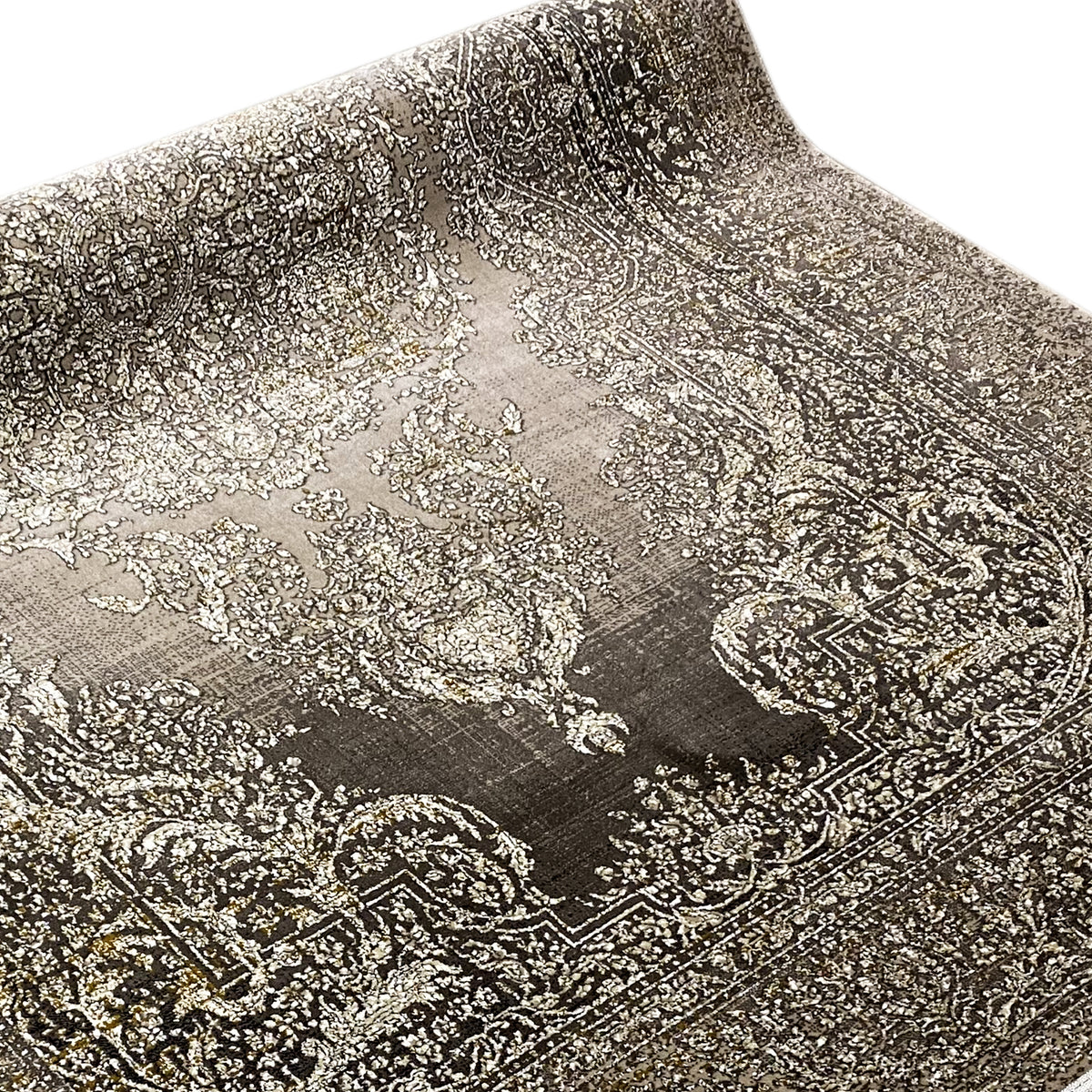 Carpet surface with a large ornamental pattern in beige and dark gray, close-up