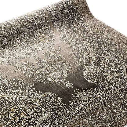 Carpet surface with a large ornamental pattern in beige and dark gray, close-up