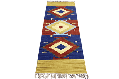 Wool kilim runner with geometric diamonds in blue, red and cream, yellow edging, fringes