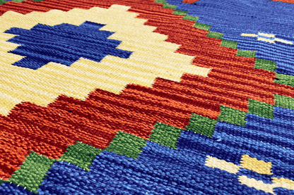 Woven wool kilim runner with a colorful pattern of blocks and dots, detailed texture