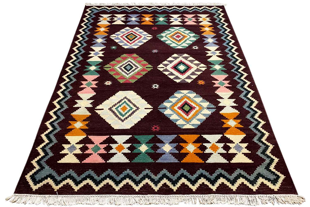 Triangle-shaped kilim rug with colorful diamonds and a zigzag border, dark red, fringes