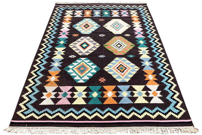 Kilim rug with zigzag and square patterns, black base, turquoise, orange and white