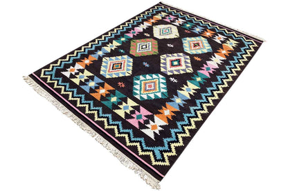 Kilim rug with tribal zigzag border, diamonds, and colorful accents on a dark background