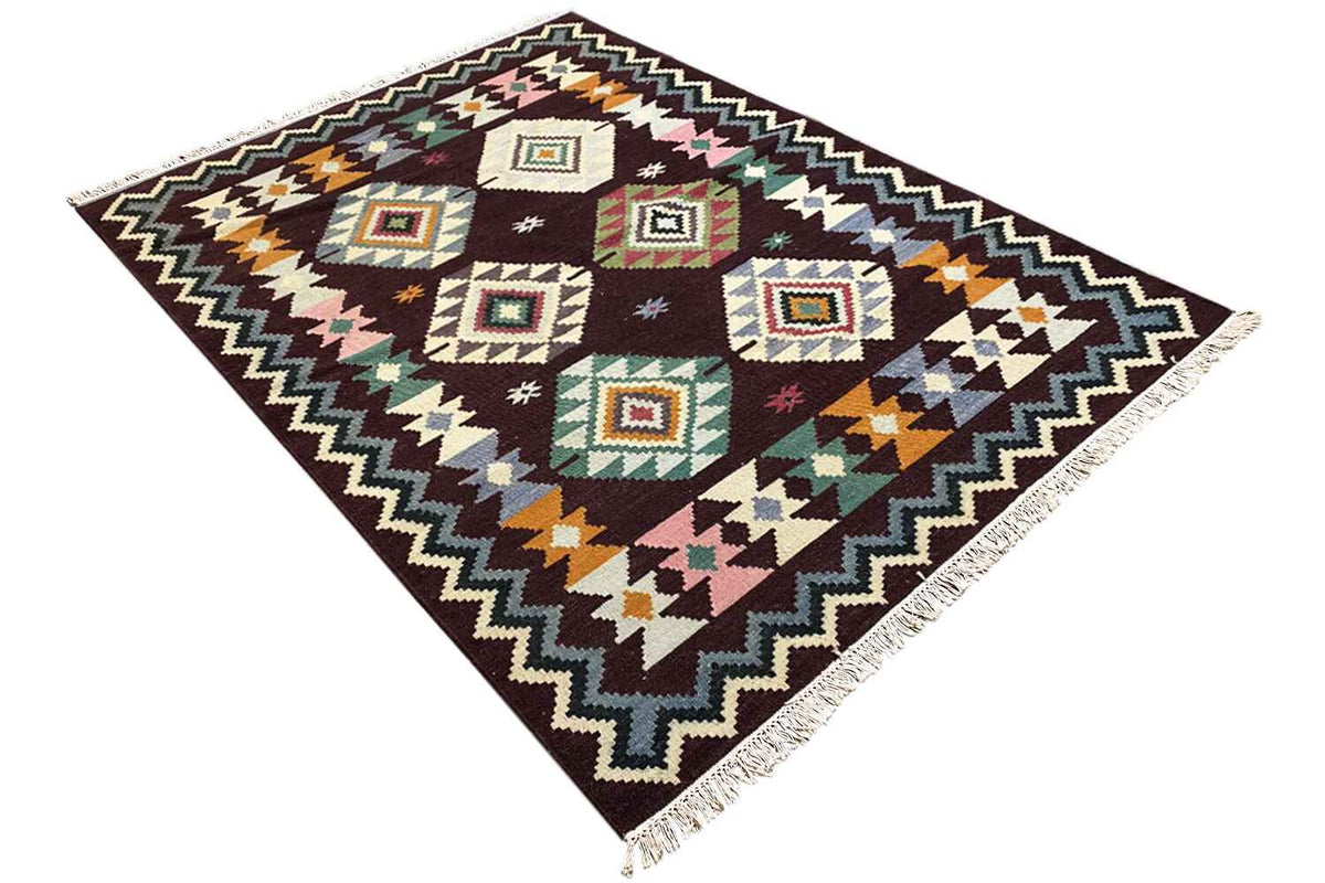 Wool kilim rug, diagonal view, multicolored squares in a zigzag frame