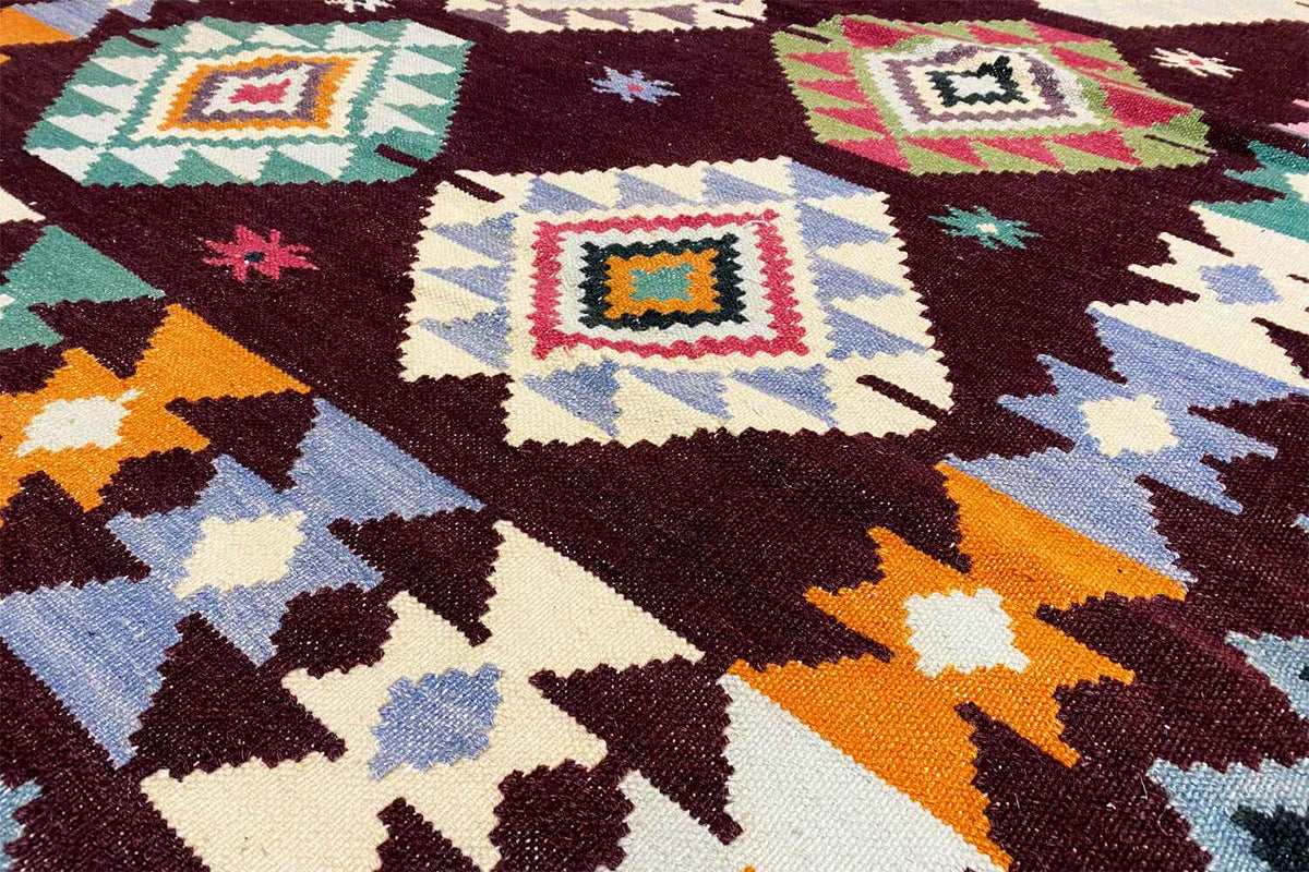 Wool kilim rug detail, woven diamonds and zigzags in dark red and turquoise