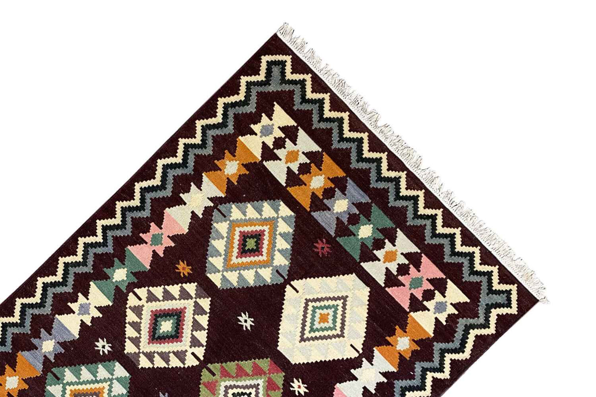 Wool kilim rug close-up, corner motif with zigzag border and wool fringe
