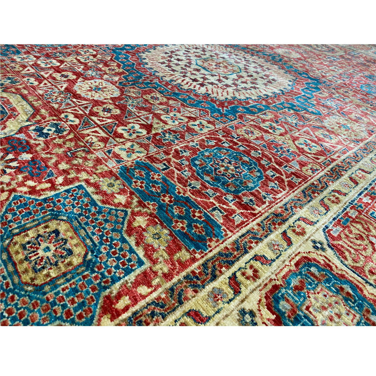 Close-up of a Mamluk rug: woven ornament in blue, red, and cream, dense pile