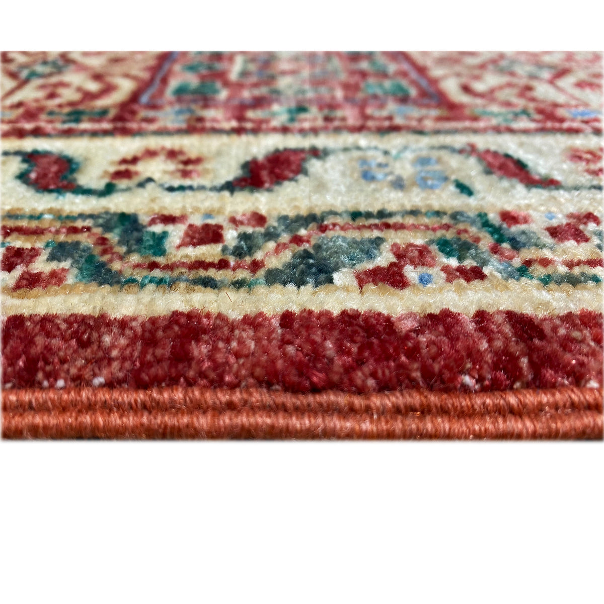 Close-up of a red Mamluk rug: pile and border, colorful patterns, fringes