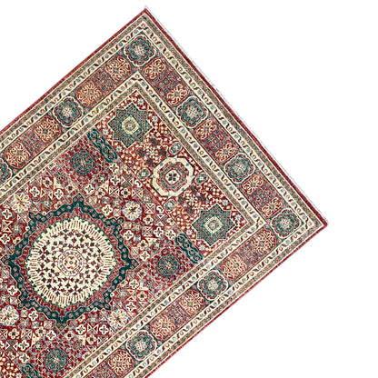 Close-up of a red Mamluk rug: corner motif and medallion, with a surrounding border
