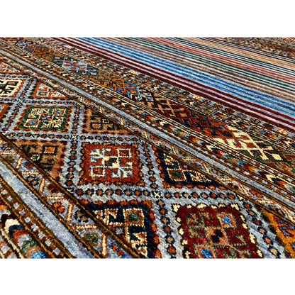 Close-up: colorful Khorjin rug with intricate diamonds, ornaments, and a fringed border