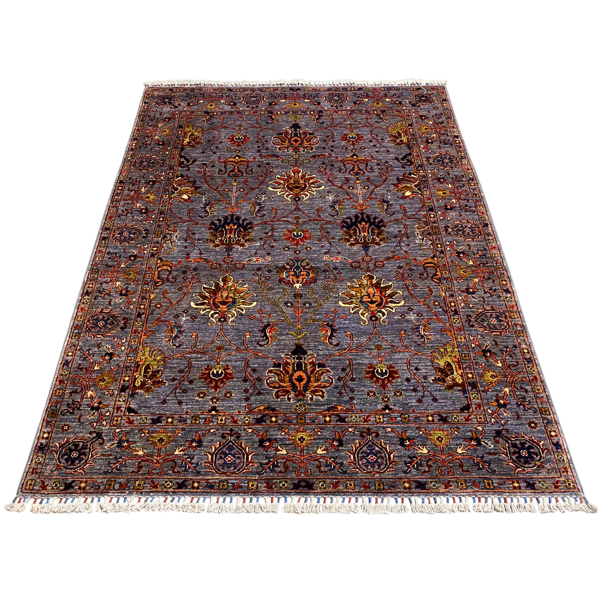 Gray Oriental rug with a floral ornamental pattern, a border all around, and fringes