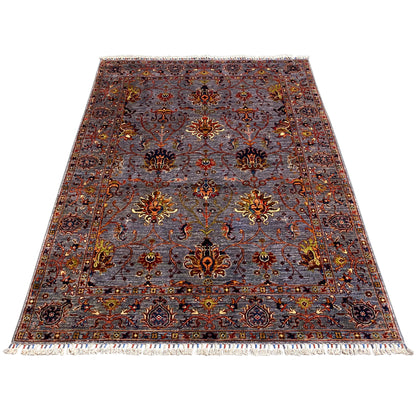 Gray Oriental rug with a floral ornamental pattern, a border all around, and fringes