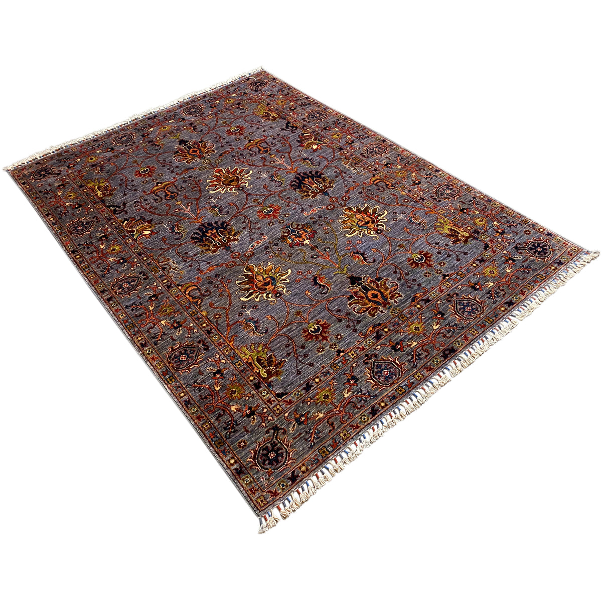 Gray oriental rug with floral ornaments, corner area with border and fringe