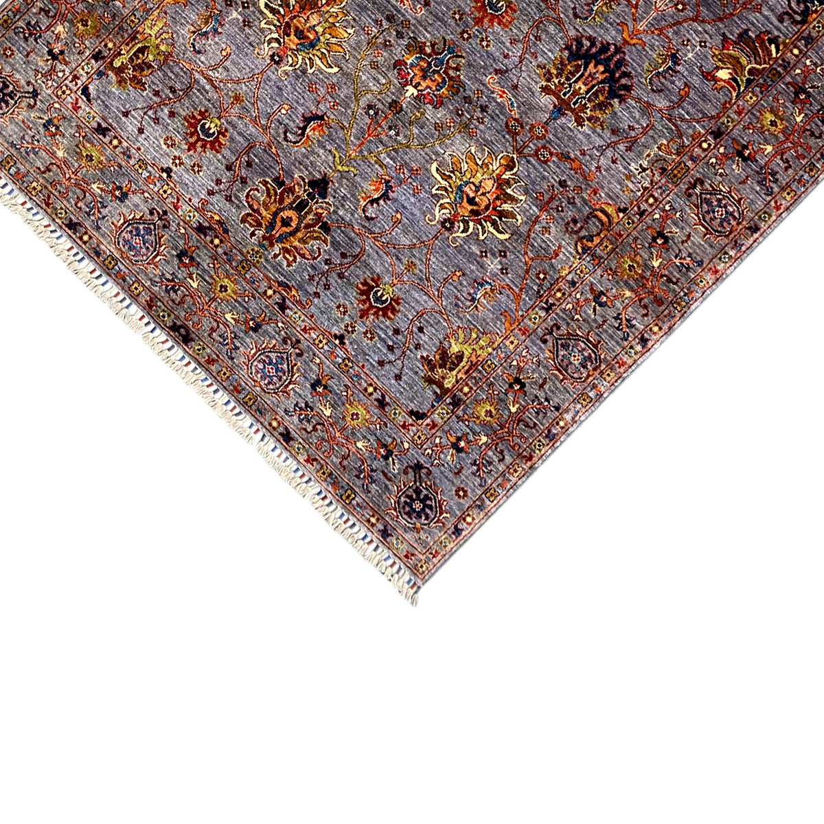 Border detail: gray oriental rug with floral ornaments and fringes