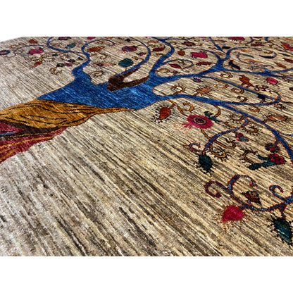 Detail of the beige rug: blue tree, red flowers, and ornamental vines