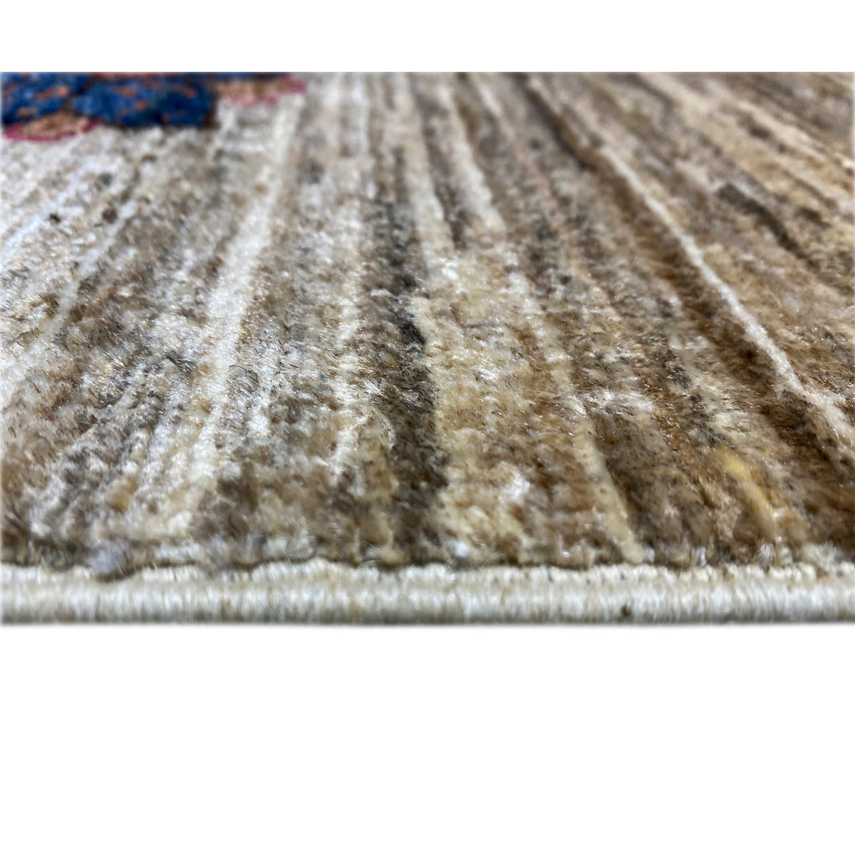Beige carpet pile with a delicate pattern and colorful accents, close-up view