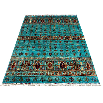Turquoise rug with a multicolored ornamental pattern and fringes, rectangular