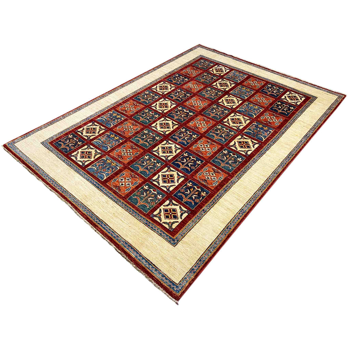 Rug viewed from above: geometric floral pattern with red, blue, and cream-colored fields