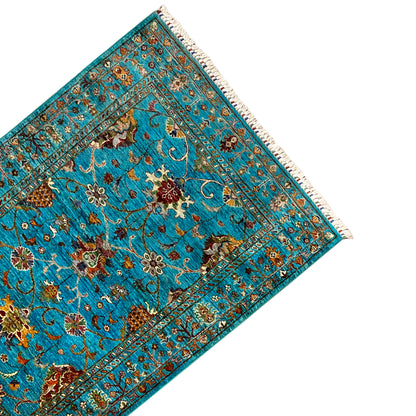 Turquoise Khorjin rug, diagonal view of the pattern with decorative borders