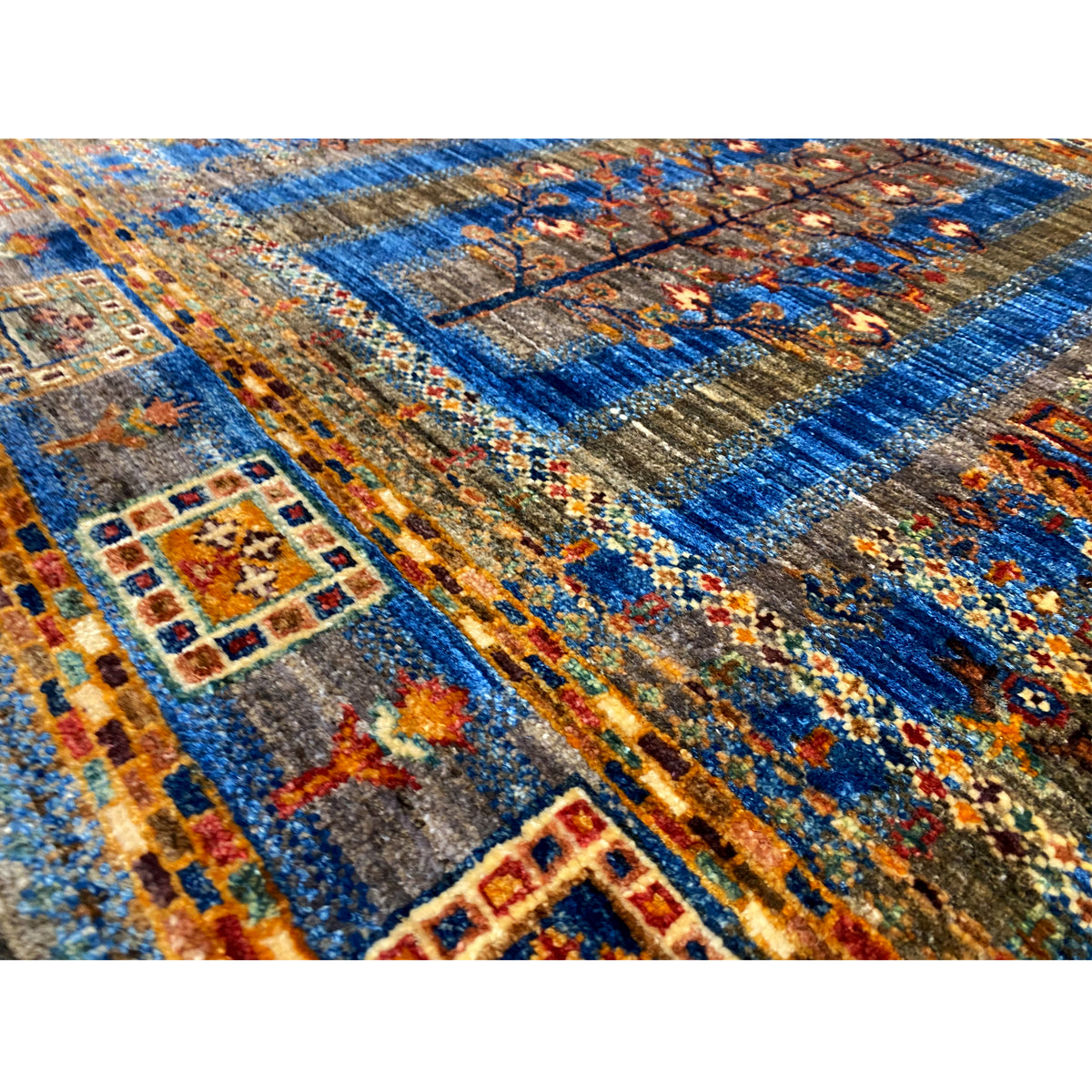 Carpet pattern in blue, brown, and orange with tile ornaments and subtle color blends