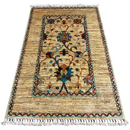 Beige Khorjin rug 126x85 cm with central ornamental field, decorative border, and fringes