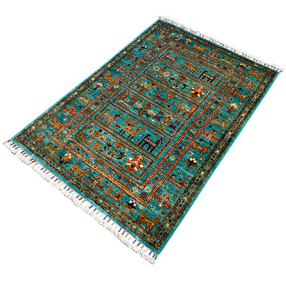 Turquoise Khorjin rug spread out, with decorative border lines and fringe along the edge.