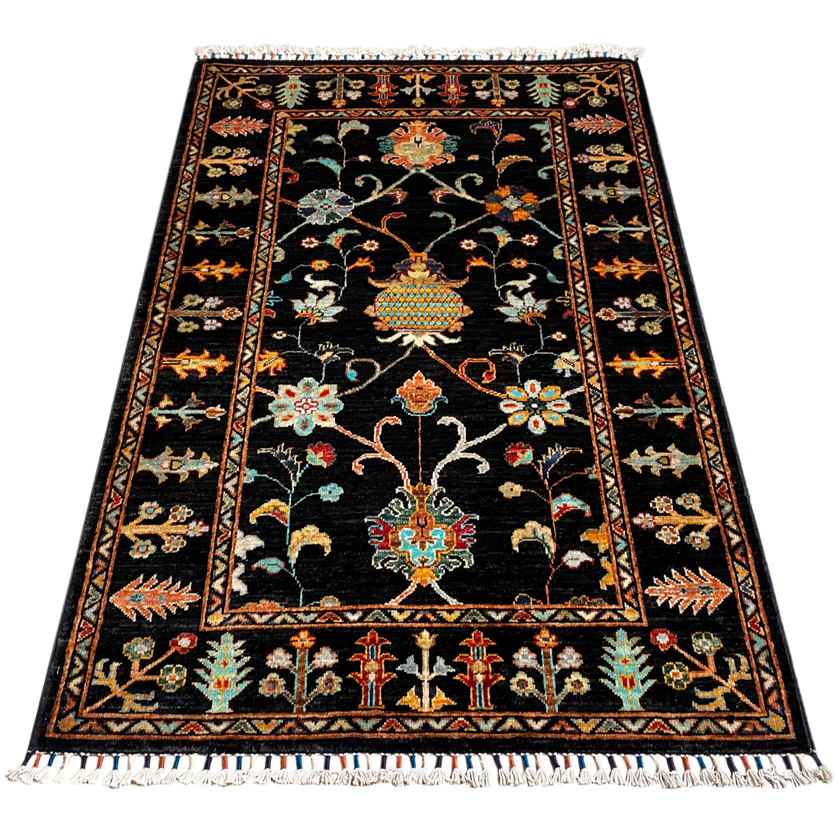 Khorjin rug with a dark background and colorful pattern, surrounding border, and fringes