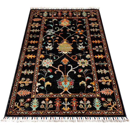 Khorjin rug with a dark background and colorful pattern, surrounding border, and fringes