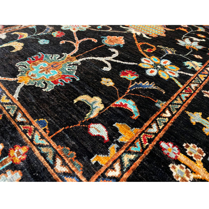 Close-up of a Khorjin rug: dark field with multicolored flowers, vines, and a geometric border