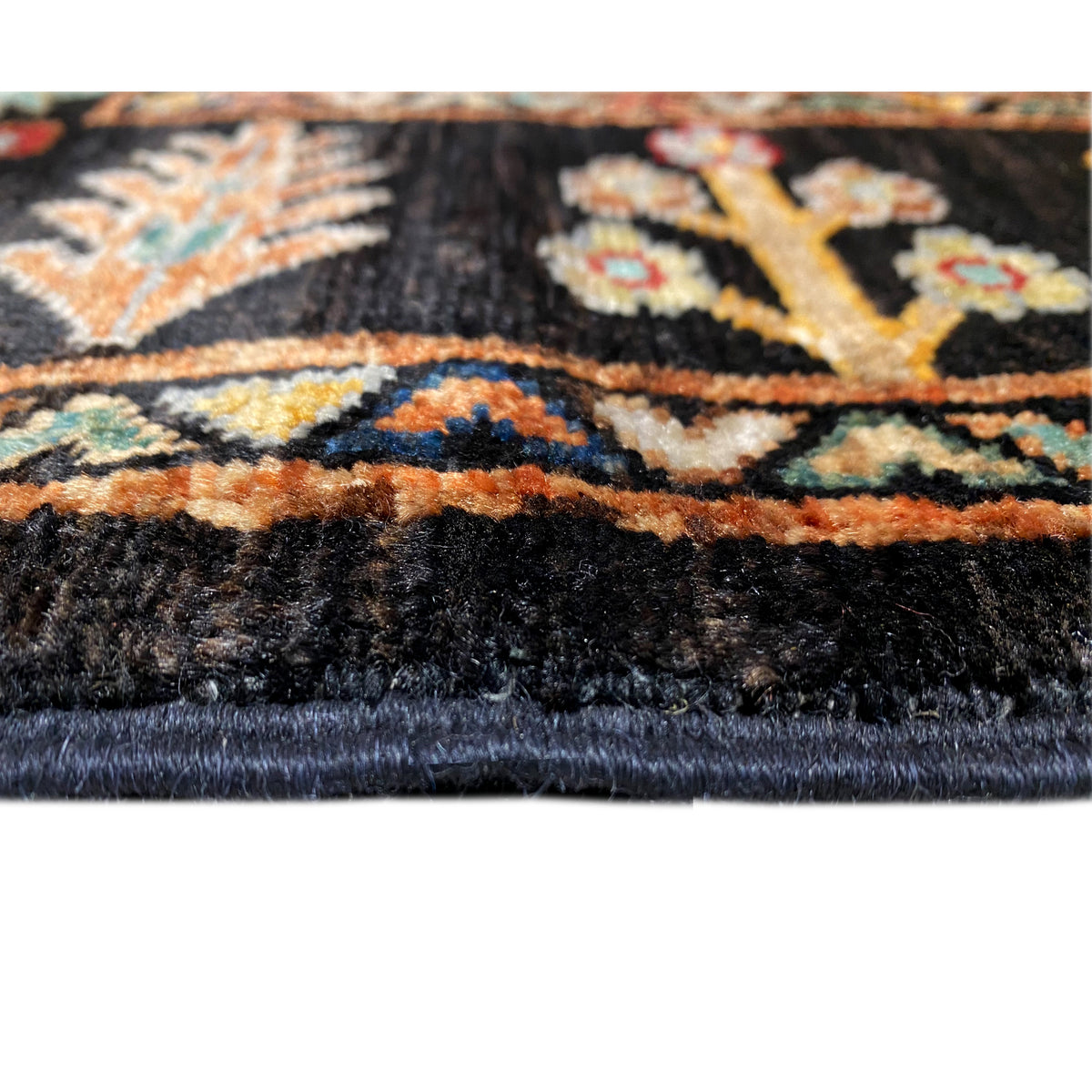 Khorjin rug 143x96 cm close-up of the edge: black pile, colorful border, fringes