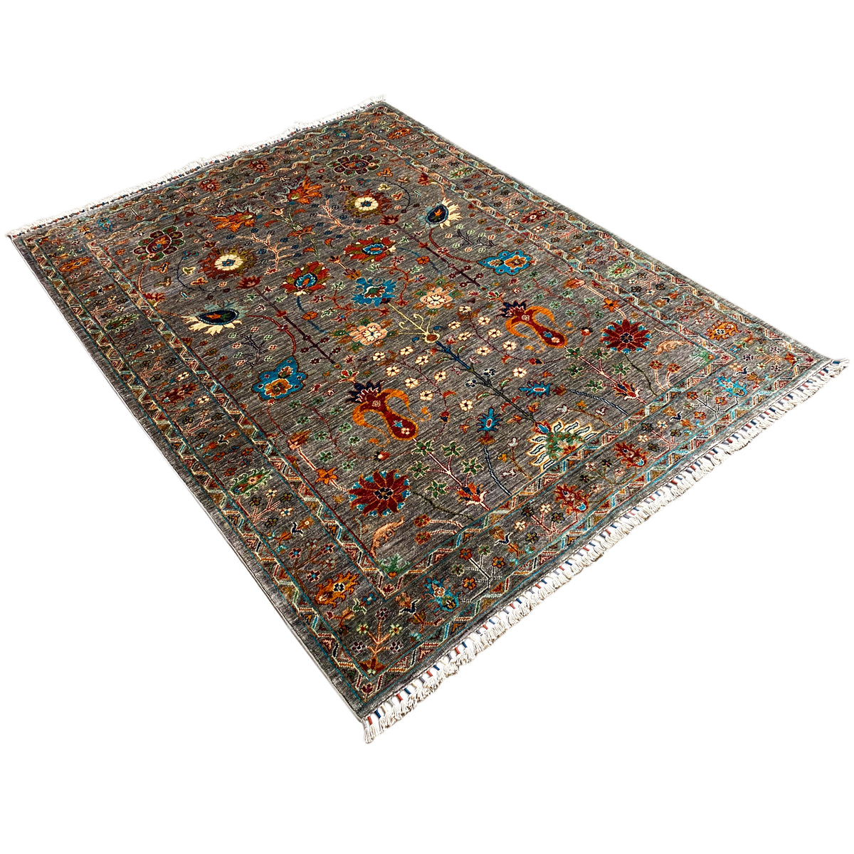 Gray Khorjin rug viewed diagonally; multicolored ornamental pattern and bound edges