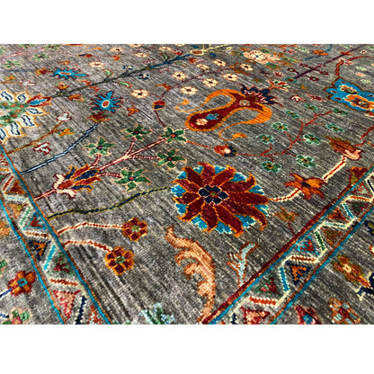 Close-up of Gray Khorjin rug: dense ornamental pattern with colorful flowers, lines, and filler motifs