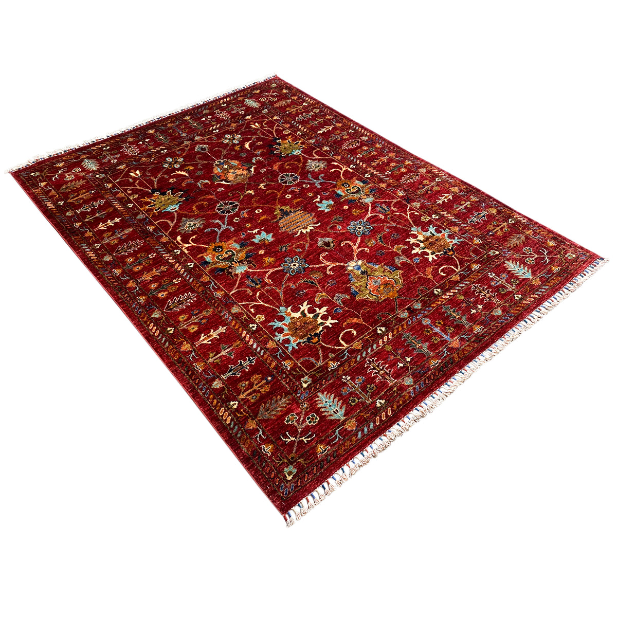Red Khorjin rug at an angle, detailed ornamental pattern, fringed edges