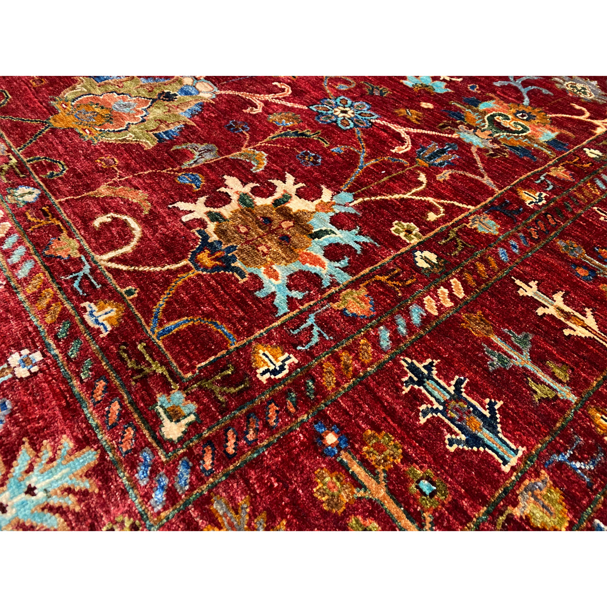 Close-up of the red Khorjin rug with colorful ornaments and fine details