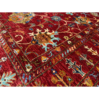Close-up of the red Khorjin rug with colorful ornaments and fine details