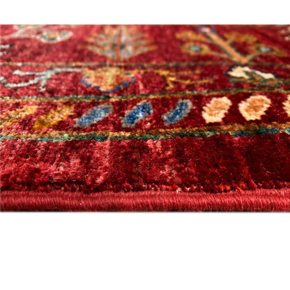 Detail of the carpet pile: red fabric with multicolored patterns and a visible edge
