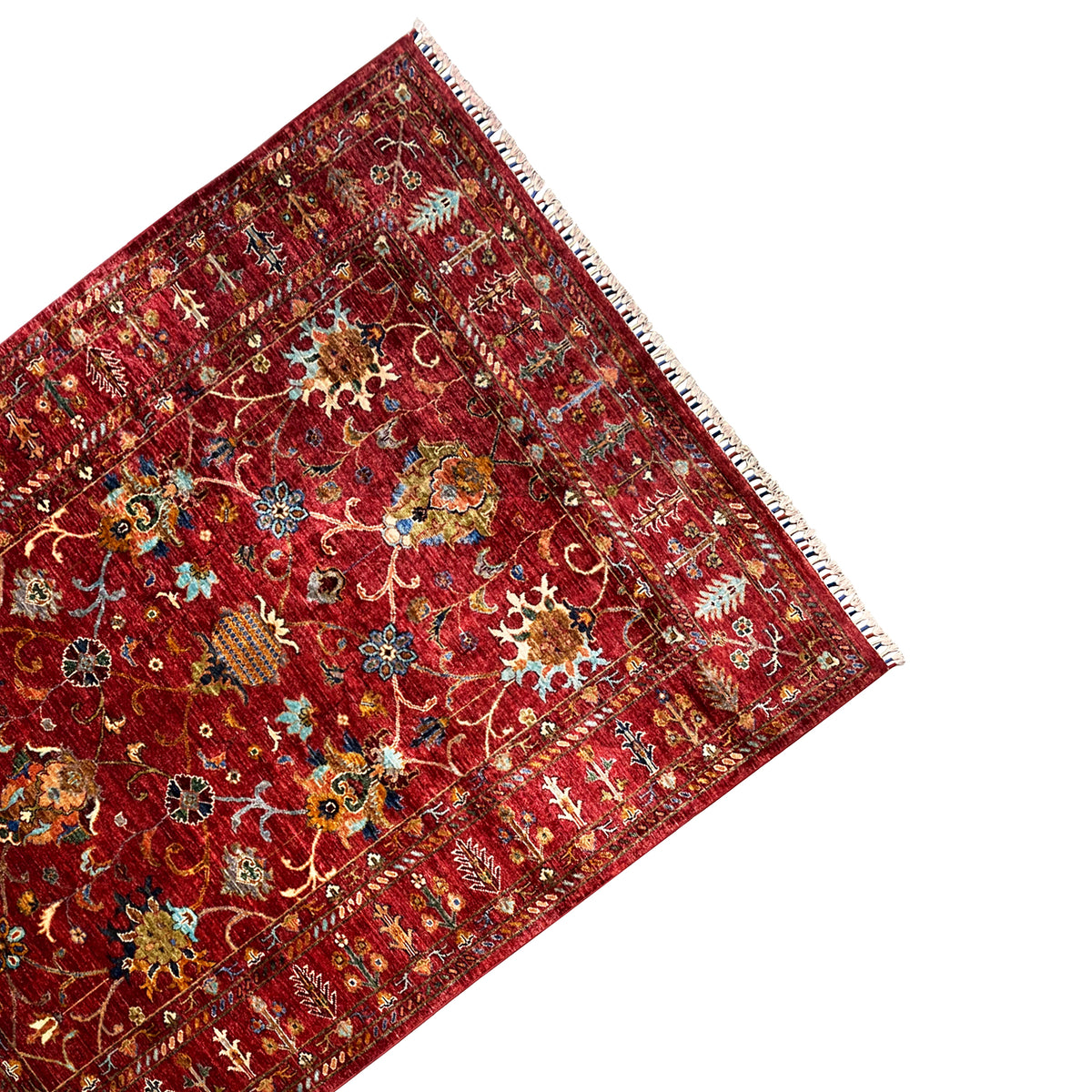 Red Khorjin rug corner view, border and ornament panel, fringe along the edge