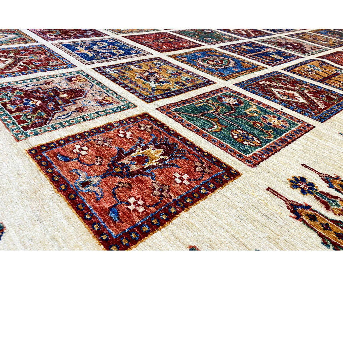Wool rug detail with colorful tiles in blue, red, and green on a light background