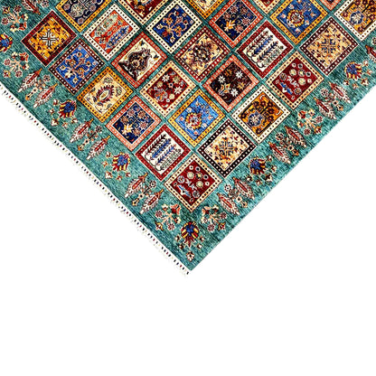 Ziegler carpet corner close-up with tile ornaments and fringes, petrol-blue background