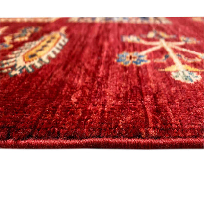 Ziegler carpet detail, red pile with woven motifs in blue, beige, and gold
