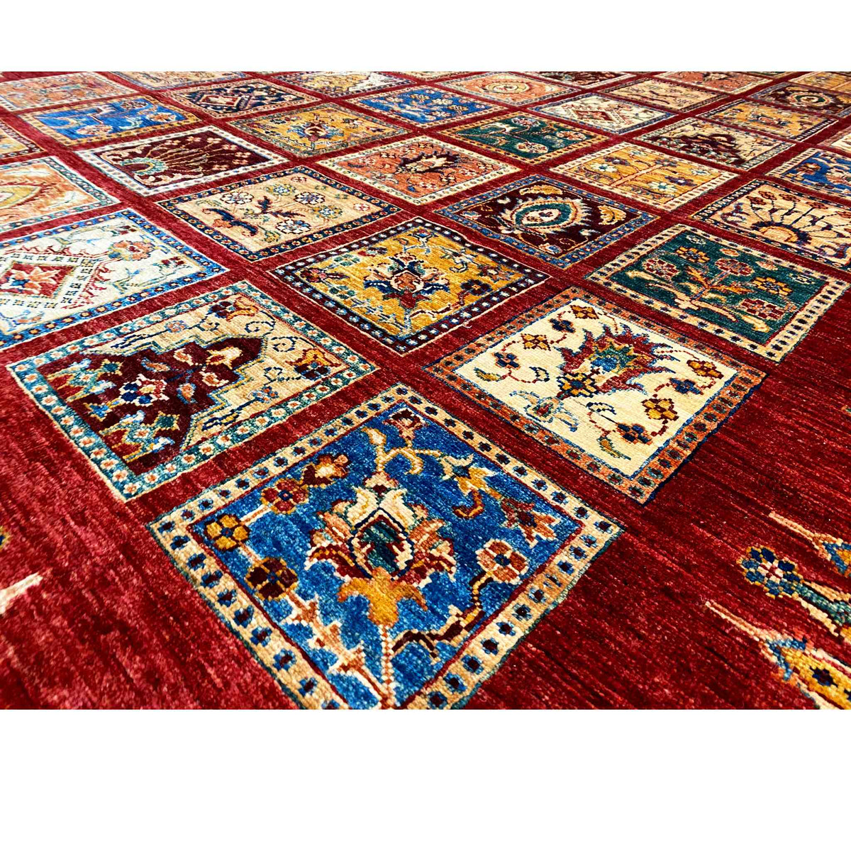 Ziegler rug detail, multicolored ornamental squares on a red background