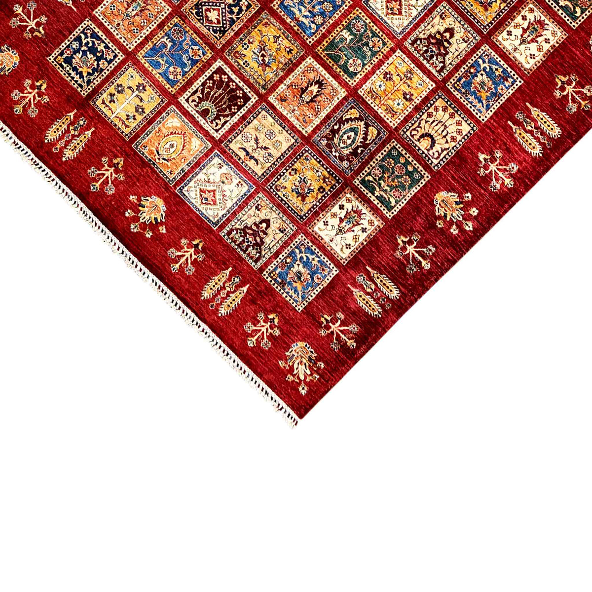 Ziegler rug corner, red background with colorful squares and white fringes