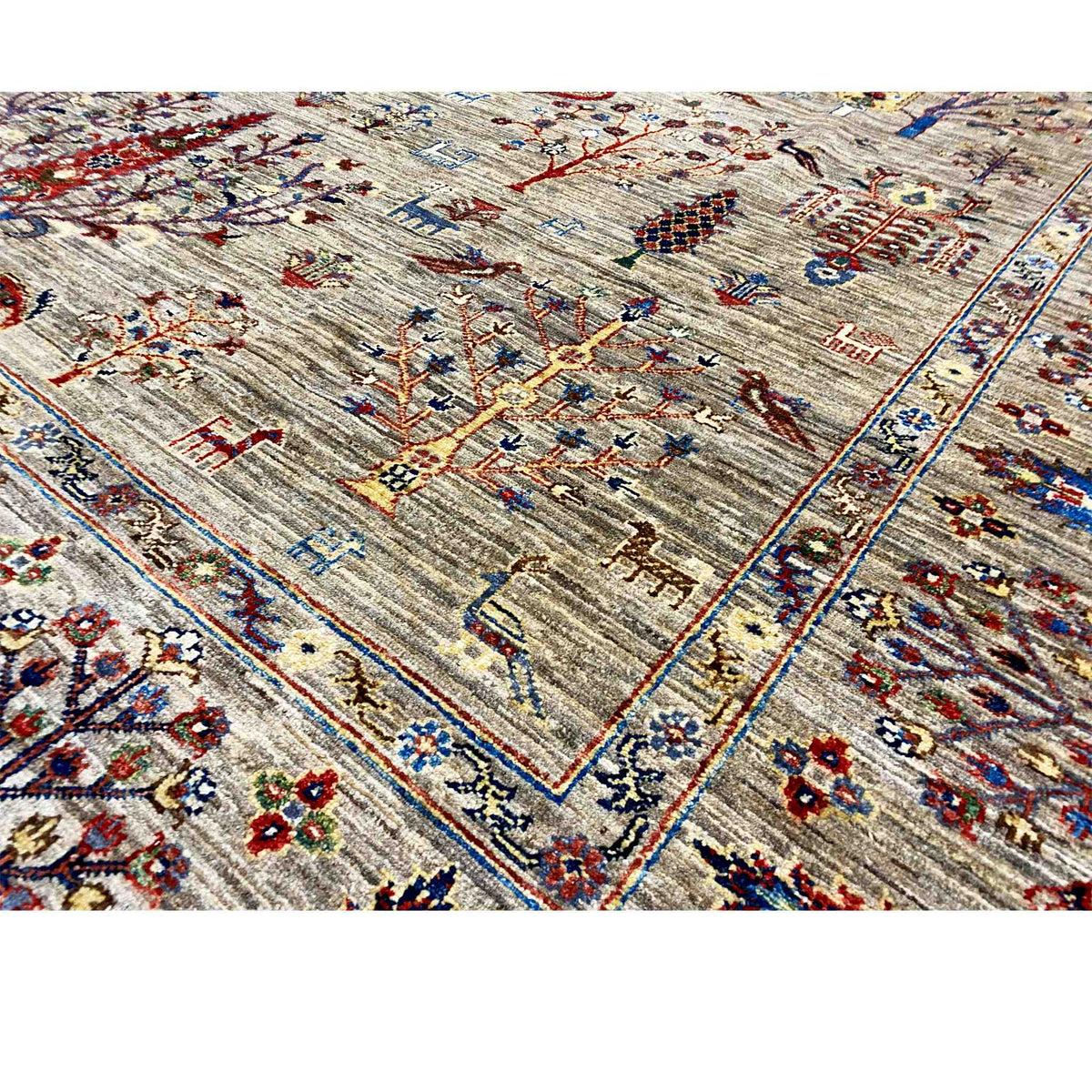 Close-up of a Ziegler rug with a geometric border and colorful medallion motifs