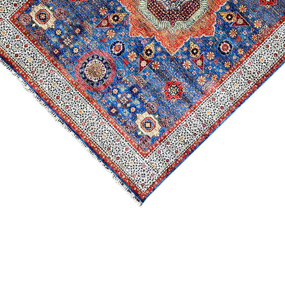 Ziegler carpet corner close-up: beige ornamental border, blue field, short fringe