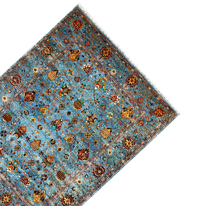 Corner view: blue carpet with ornamental medallions and a decorative border