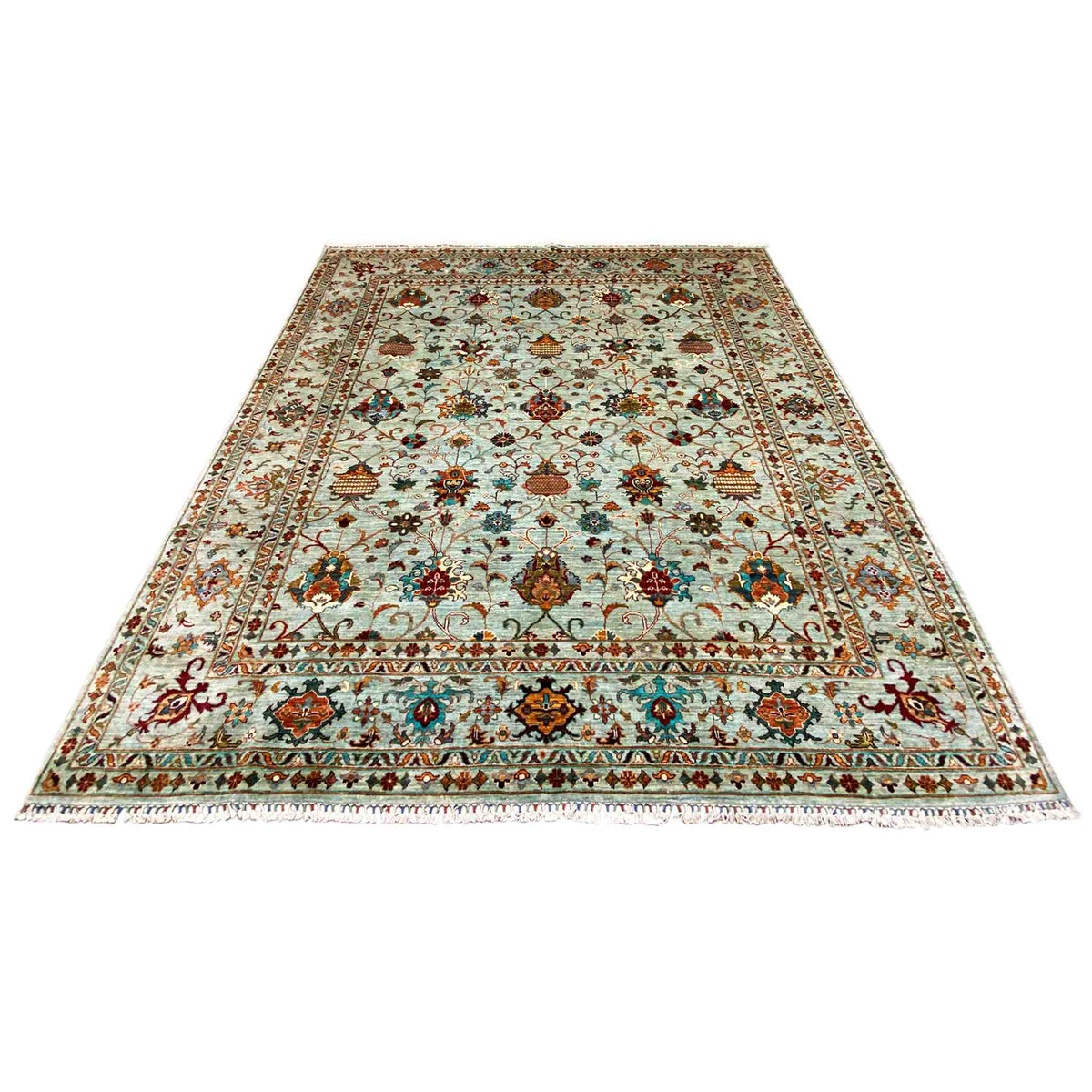 Rug laid flat with a decorative floral and ornamental pattern in light blue