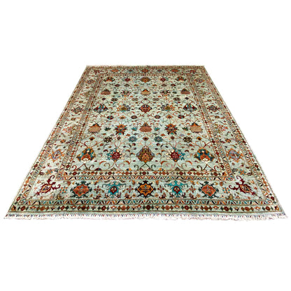 Rug laid flat with a decorative floral and ornamental pattern in light blue