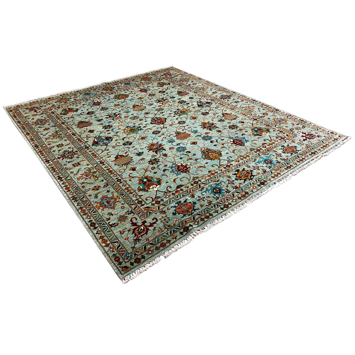 Carpet in a 3/4 view with a light blue background and an intricate ornamental pattern