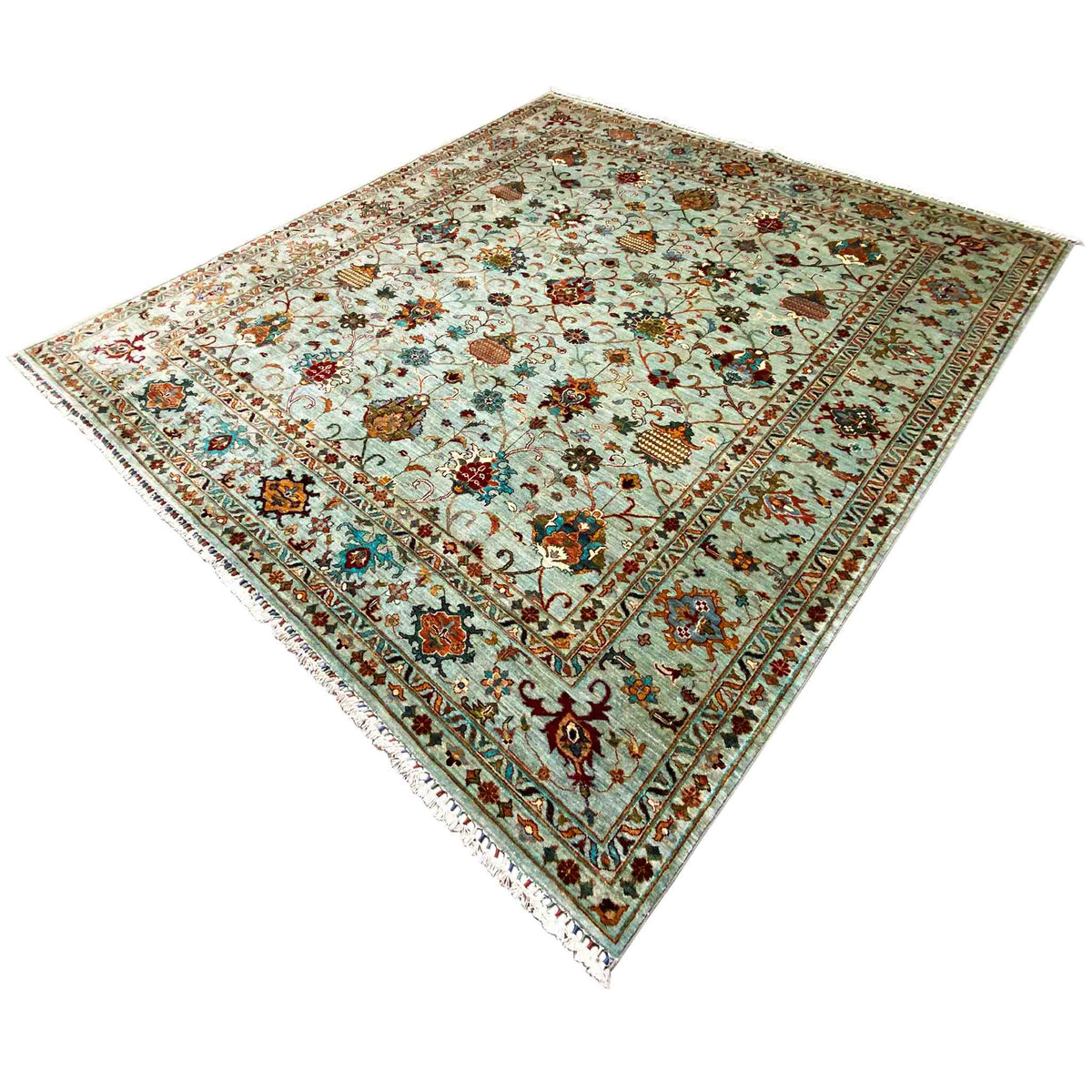 Rug at an angle: light blue pile with a multicolored floral and vine pattern