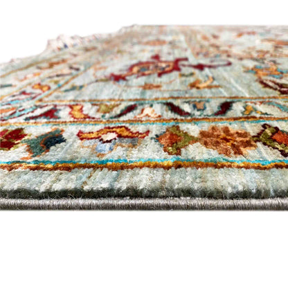 Close-up of a carpet edge with a multicolored pattern and woven pile